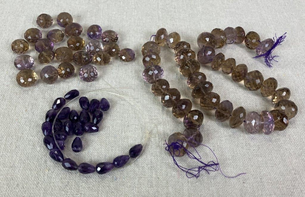 Assortment of Mixed Stone Amethyst and Ametrine Beads: Assorted grouping of faceted amethyst beads and ametrine stones, the latter displaying natural color zoning characteristic of combined amethyst and citrine quartz. One larger ametrine bead measures