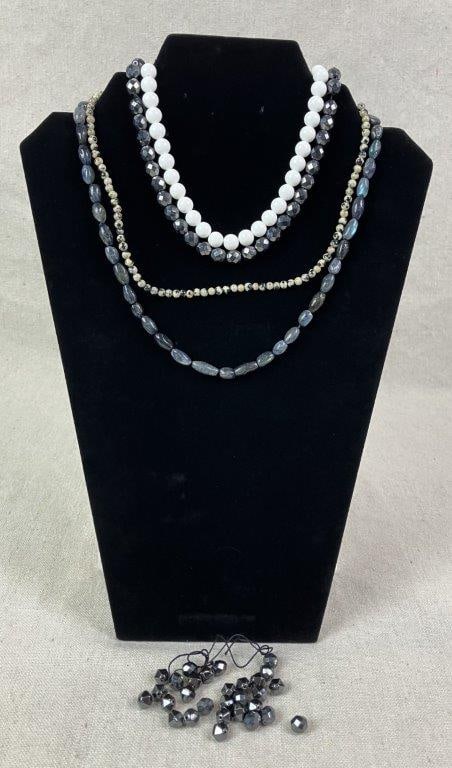 Lot of Stone Beads: Group of stone beads including a strand of labradorite beads with reflective sheen, a strand of Dalmatian jasper sphere beads, assorted faceted hematite beads, and a strand of white marble beads.