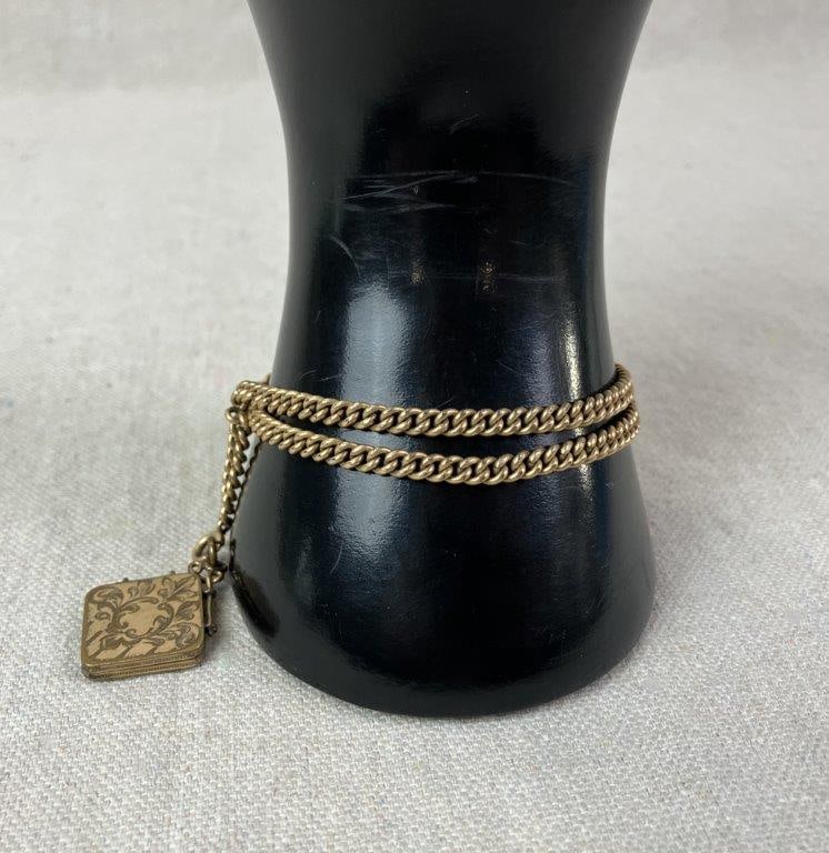 Late 19th Century Women’s Chatelaine Chain: Late 19th to early 20th century women's chatelaine chain in rich gold tone finish, designed for attachment to a vest or coat pocket and suitable for use as a pocket watch chain. Includes a small