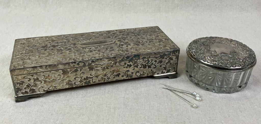 Silverplate Vanity Powder Jar and Jewelry Box: Elegant silverplate vanity grouping including a powder jar with embossed floral silverplate lid atop a clear glass body, and a coordinating jewelry box with dimensional leaf and vine decoration in