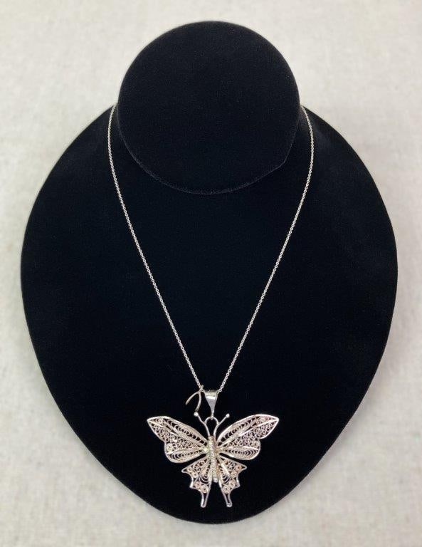 Sterling Silver Turkish Filigree Butterfly Necklace: Delicate sterling silver butterfly pendant crafted in intricate Turkish filigree, displaying a lace-like openwork pattern. Marked 925 and "Turkey" to bail. Suspended from a coordinating chain.