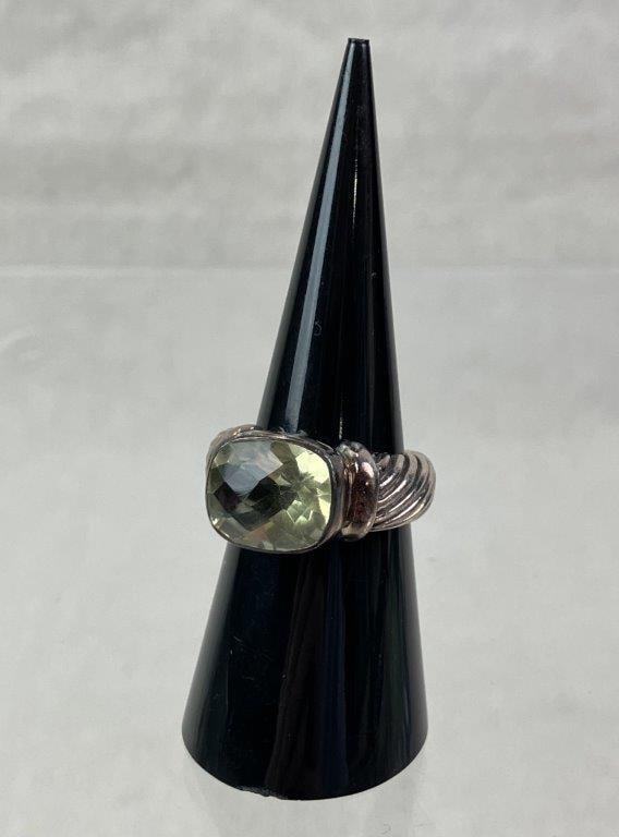 Sterling Silver and Prasiolite Ring: Sterling silver ring featuring a raised gallery with cross motif incorporated into the openwork reticulated design. Band detailed with swirling elements in a robust form, centering a faceted