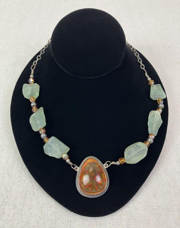 Sterling Silver, Amber, and Prehnite Artisan Necklace: Artisan-crafted necklace featuring a central amber stone set within an elegant sterling silver mount, suspended from a chain composed of raw prehnite stones, faceted amber beads, and silver bead