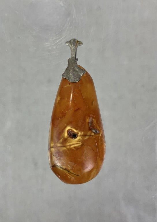 Amber and Sterling Silver Statement Pendant: Statement pendant featuring a natural amber stone with rich internal variation, set with a sterling silver bail. Marked â€œMETâ€ for maker; unmarked for silver content