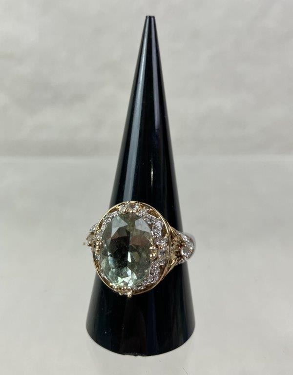 Sterling Silver and Prasiolite Cocktail Ring: Elegant cocktail ring crafted in sterling silver, centering an oval-cut faceted prasiolite stone. Accented with rose gold vermeil details, featuring an elaborate filigree and openwork gallery with