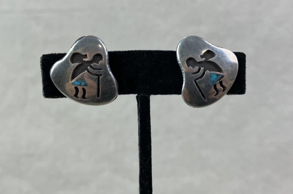 Native American Sterling Silver Kokopelli Turquoise Inlay Earrings: Pair of Native American sterling silver earrings featuring the distinctive Kokopelli figural motif, symbolizing fertility, music, and joy. Each figure is accented with triangular turquoise inlay set