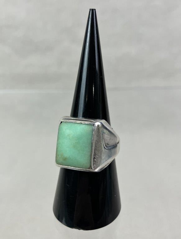 Native American Sterling Silver and Turquoise Ring: Native American artisan-crafted ring featuring a square light green turquoise cabochon set within a substantial sterling silver band of streamlined form. Ring size approx. 8. Unmarked but tested for s