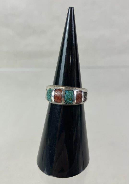 Native American Sterling Silver, Turquoise, and Coral Inlay Ring: Native American ring featuring alternating chip inlays of turquoise and coral set within a sterling silver band terminating in a decorative motif. Ring size approx. 4. Total weight including stones ap