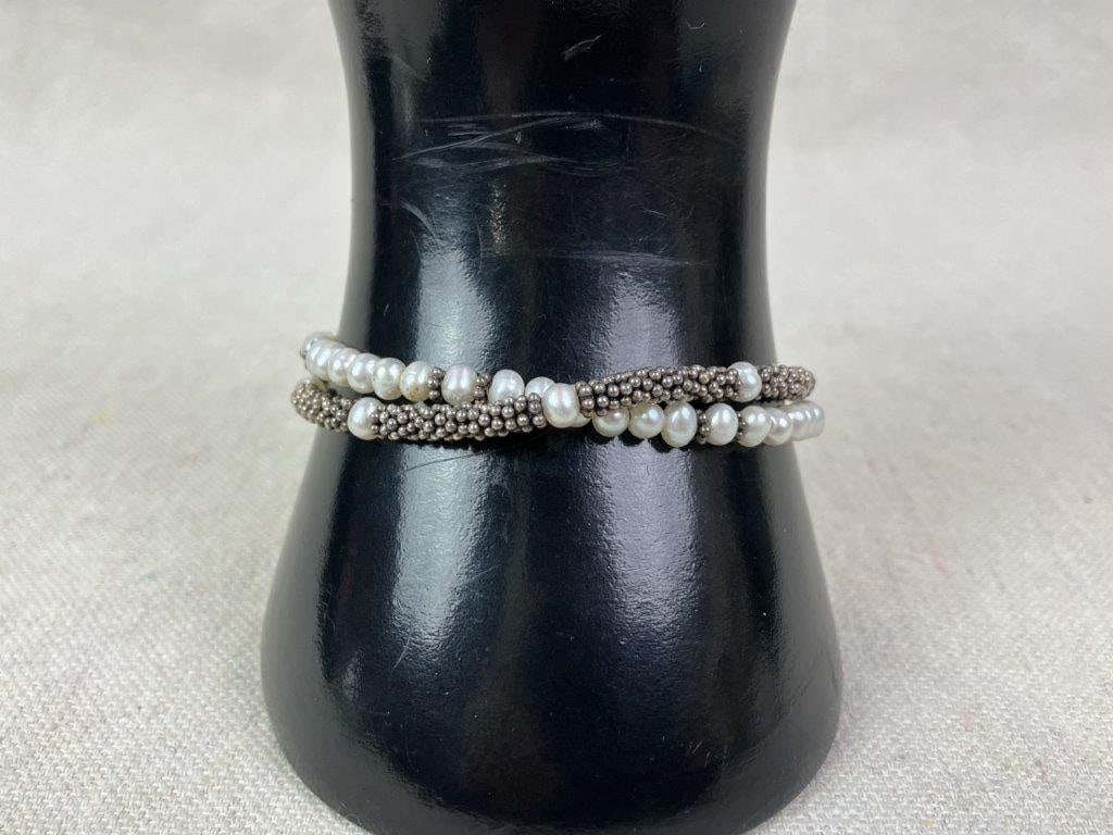 Sterling Silver, Mother-of-Pearl, and Pearl Bracelet: Sterling silver bracelet in a caviar-style design featuring silver beading and pearl beads, centered by a mother-of-pearl box clasp framed within a complementary sterling setting. Marked for sterling