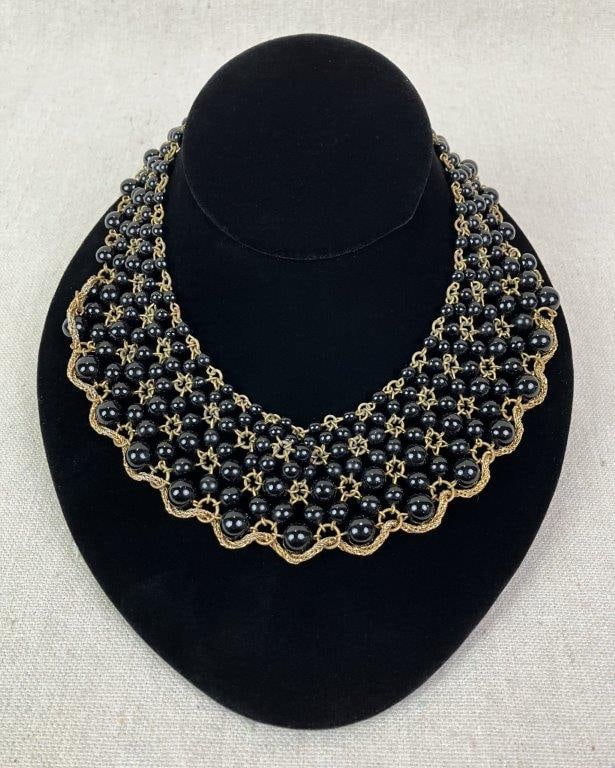 Vintage Multistrand Black Glass Bead Collar Necklace: Vintage collar-style necklace composed of multiple strands of black glass beads joined by goldtone interconnected chain links and finished with a decorative box clasp. Measures approx. 10" L. In good