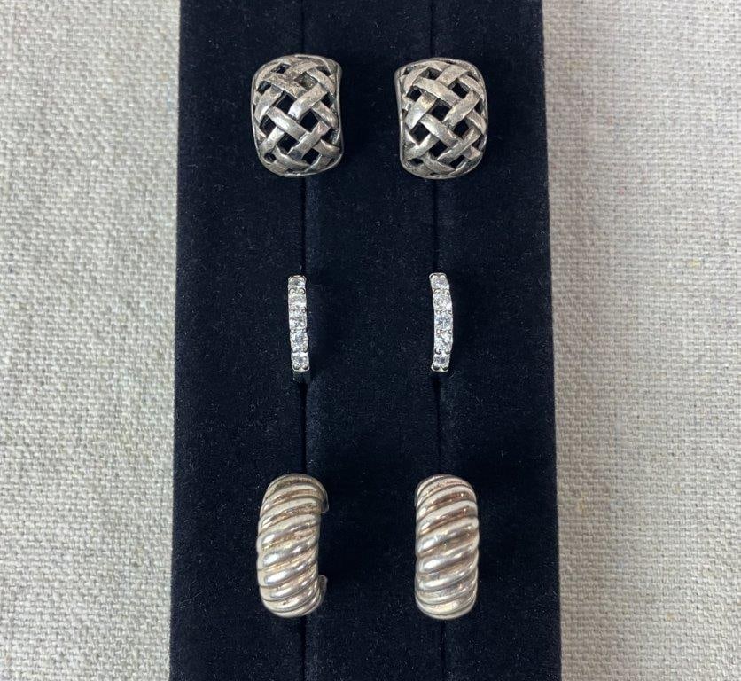 Three Pairs of Sterling Silver Hoop Earrings: Group of three pairs of sterling silver earrings including one pair of shrimp-style chunky hoop earrings with ribbed design stamped 925, one pair of huggie hoops set with small cubic zirconia stamped