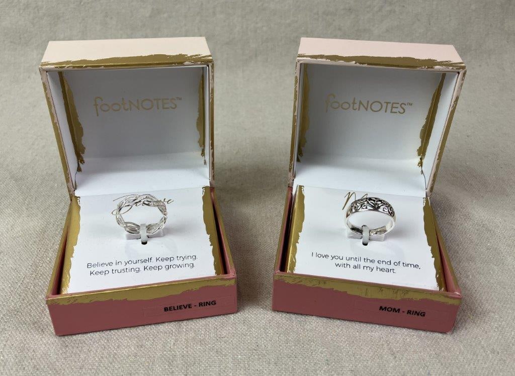 Two Sterling Silver Footnotes Rings: Two sterling silver Footnotes brand rings including one embodying the motto “Believe” rendered in interlocking linear linework, and one “Mom” design featuring intricate pierced