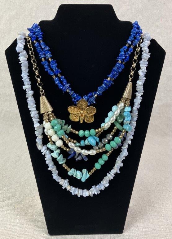 Three Beaded Necklaces: Grouping of three beaded necklaces including one composed of faux lapis lazuli stones accented by a central goldtone floral element, one featuring an assortment of faux pearls and faux turquoise