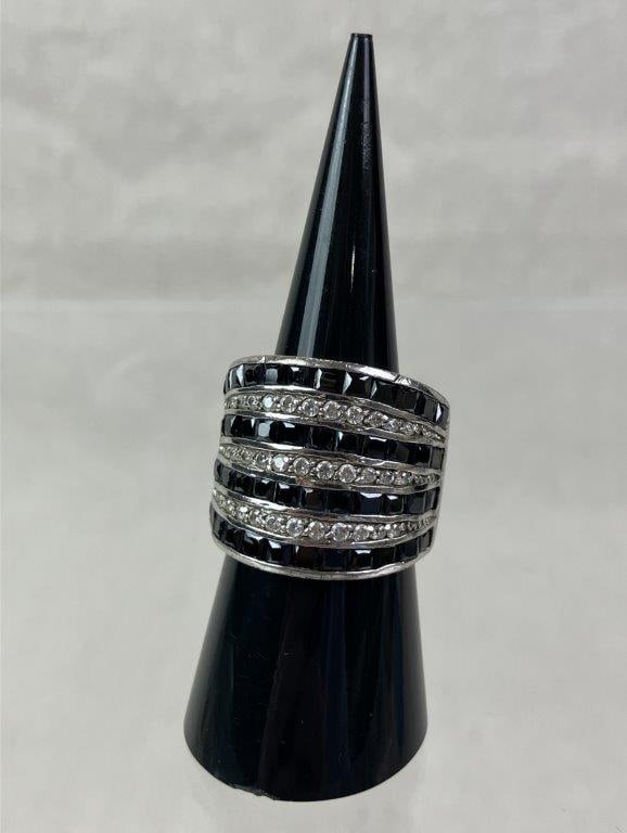 Sterling Silver and Hematite Statement Ring: Sterling silver statement ring marked for silver content, designed with alternating rows of faceted black hematite and clear faceted stones set within a simple yet robust band. Ring size approx. 7. To
