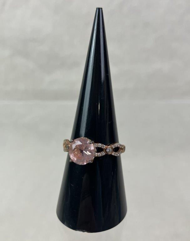 Sterling Silver Gold Vermeil and Morganite Ring: Elegant ring crafted in sterling silver with rose gold vermeil finish, featuring a central round brilliant-cut pale pink stone (possibly morganite) set within a raised gallery accented by clear