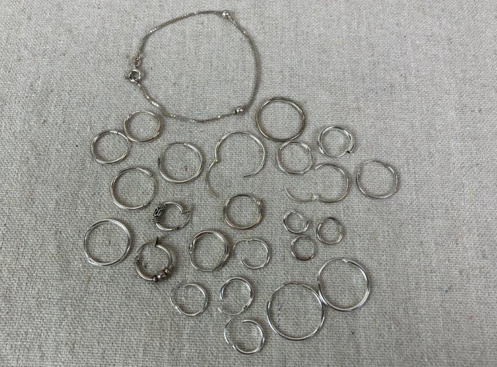 Sterling Silver Hoop Earring and Bracelet Lot: Assorted sterling silver jewelry lot including multiple hoop earrings and one delicate bracelet. Bracelet measures approx. 6" L. Total weight approx. 10.67g. In good overall condition with light wear