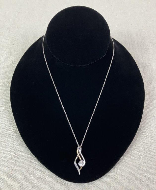 Sterling Silver and 10KT Gold Diamond Infinity Necklace: Necklace featuring a central infinity scrollwork pendant crafted in sterling silver and 10K gold, accented with small diamonds arranged in a pavé-style setting to the center and along the sides.