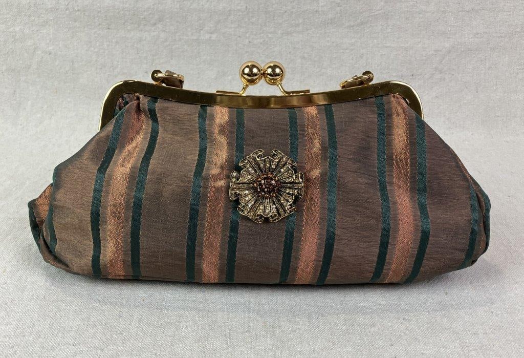 Cadari London Striped Evening Bag with Floral Adornment: Structured evening bag by Cadari London featuring striped fabric in autumnal tones of forest green and muted sienna. Framed in goldtone metal with a classic kisslock closure, centered by a