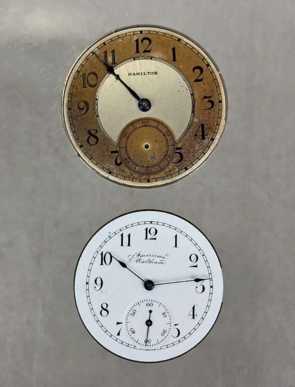 Two 20th Century Pocket Watch Movement: Group of two 20th century pocket watch movements including a Hamilton 912 movement with two-tone tuxedo-style metal dial and blue steel hand, reverse marked “Hamilton Watch Co Lancaster, PA 17