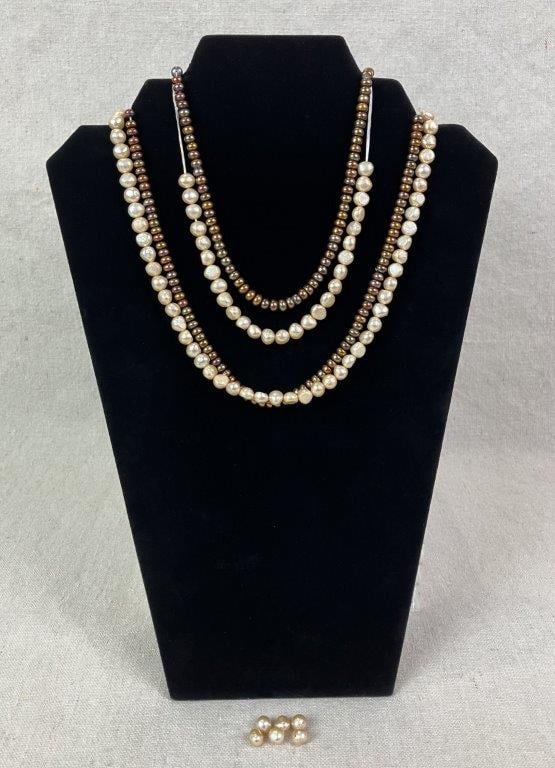 Three Strands of Freshwater Pearls: Group of three strands of freshwater pearls including one strand of cream-colored pearls and two strands of bronze-toned button pearls, the latter tied together to be worn as a necklace. Longest