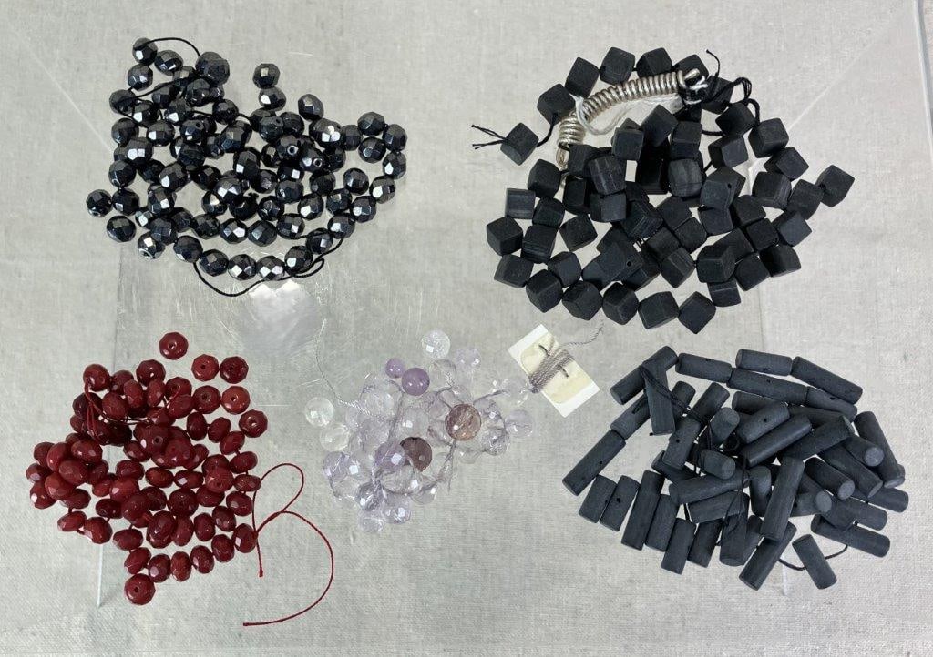Stone Bead Assortment: Assortment of stone beads including faceted hematite examples, dark crimson-toned beads, faceted light amethyst beads, and black frosted obsidian beads. Obsidian beads measure approx. 1/4" H x 1/4"
