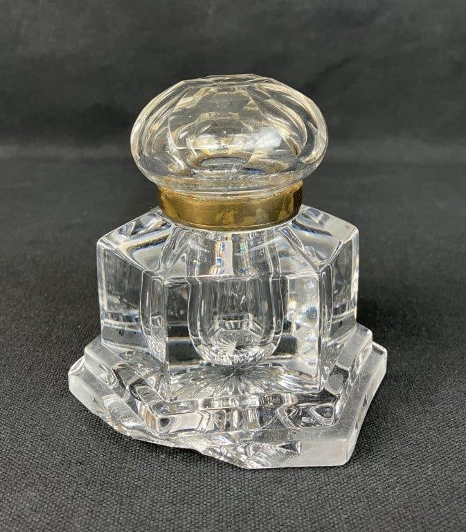 Vintage Crystal Inkwell: Vintage cut crystal inkwell of six-sided form with faceted dome lid and sunburst cut design to the base, fitted with a bronze seal. Measures approx. 4" H x 3 3/4" W x 3 3/4" D. In good overall conditi