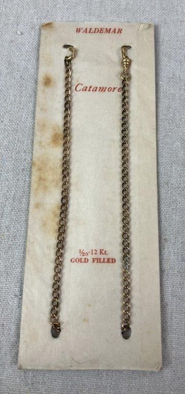 Vintage Catamore Waldemar Chain: Catamore Waldemar pocket watch chain in 1/20-12kt gold filled, still attached to original packaging. Measures approx. 13 1/4" L. In good condition with light wear; minor discoloration to packaging con