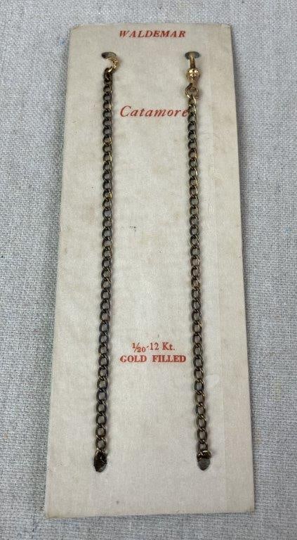 Vintage Catamore Waldemar Chain: Catamore Waldemar pocket watch chain in 1/20-12kt gold filled, still attached to original packaging. Measures approx. 13 1/4" L. In good condition with light wear; minor discoloration to packaging con