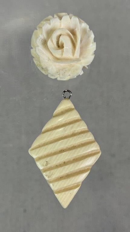 Pair of Carved Bone Jewelry Pieces: Pair of carved bone jewelry pieces including one flower-shaped brooch with delicately carved petal details and one diamond-shaped pendant with linear carved decoration. Diamond-form pendant measures