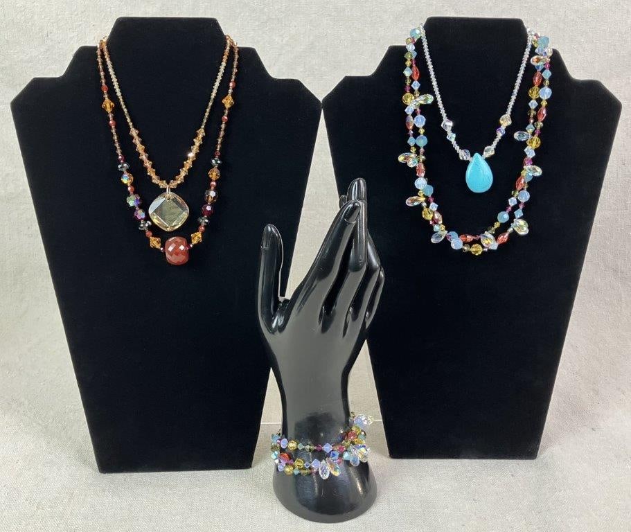 Five Beaded Jewelry Pieces: Grouping of five beaded jewelry pieces including four necklaces and one bracelet, each composed of multicolored faceted beads in varied designs. One standout necklace features clear faceted beads