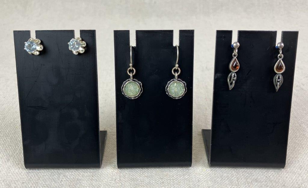 Three Pairs of Sterling Silver Earrings with Stones: Group of three pairs of sterling silver earrings including one pair set with Roman glass within round sterling silver borders stamped 925, one pair featuring teardrop-shaped Baltic amber with a