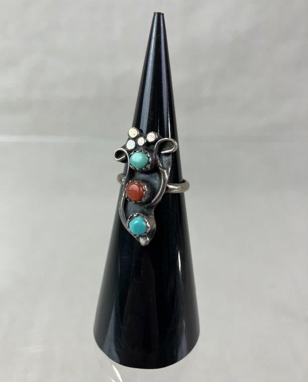 Native American Sterling Silver Ring: Handmade Native American sterling silver ring set with two blue turquoise stones and one red coral cabochon, accented by applied silver bead details in a traditional design. Ring size approx. 3.5. Tot