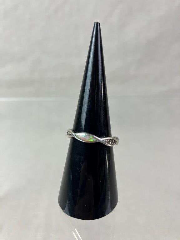 Sterling Silver and Opal Inlay Spiral Ring: Sterling silver ring designed in a graceful spiral form, inlaid with opal panels displaying iridescent flashes of color. Ring size approx. 7. Total weight including inlay approx. 2.13g. In good condit