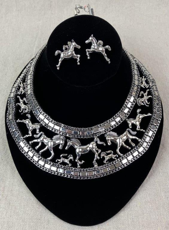 Silvertone Horse Design Bib Necklace and Earring Demi-Parure: Elegant statement demi-parure comprising a silvertone bib necklace decorated with intricate running horse motifs and coordinating silvertone beading, together with matching earrings. Necklace