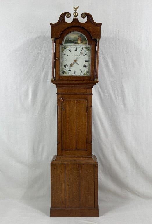 Welsh Oak Tall Case Clock, Henry Evans, Llangadock, 19th Century: Welsh oak tall case clock with a broken pediment hood surmounted by a brass eagle at the center, the scrolling swan-neck pediment ends terminating in applied roundels. The hood is supported by