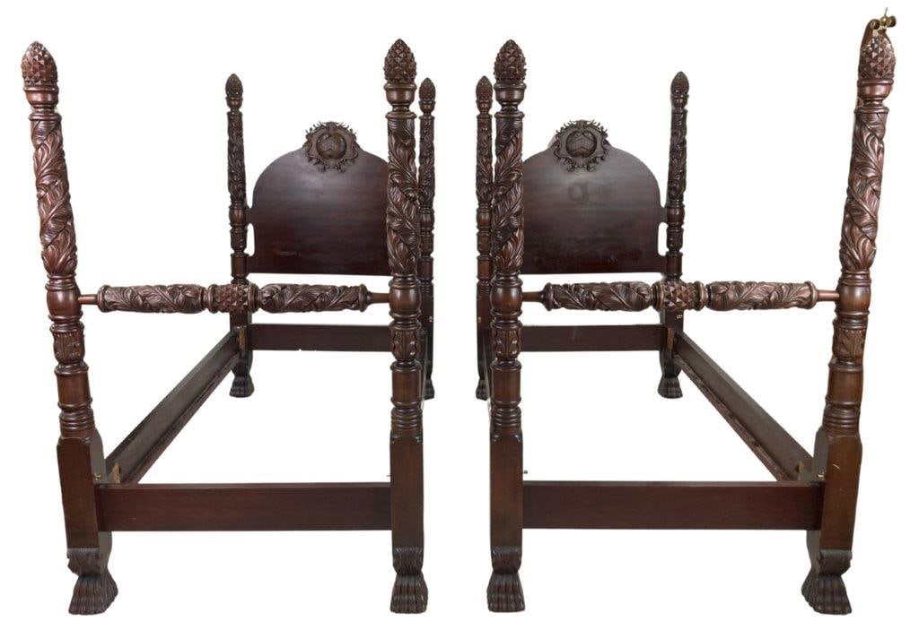 Pair of Heavily Carved Twin Poster Beds: A high-quality set of beds crafted with the dramatic scale and ornate detail characteristic of the Baroque taste. Each bed features massive turned posts decorated with intricate vegetal motif relief