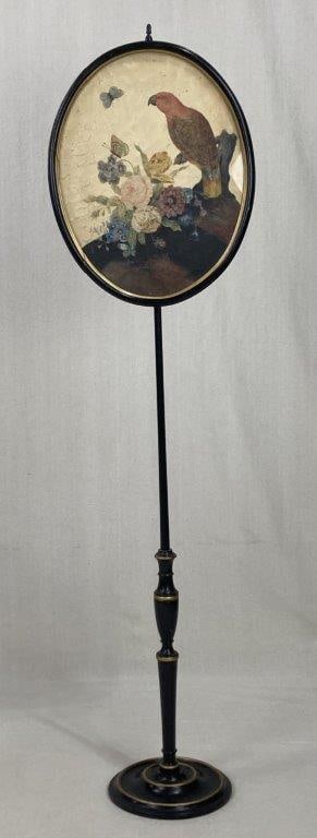 Painted Firescreen: An elegant and sophisticated hearth accessory featuring a delicately rendered watercolor painting of a vibrant parrot perched among a bouquet of blossoms, inset within a classic oval-framed screen