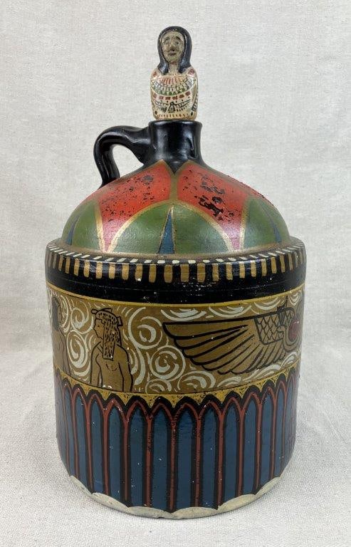 Folk Art Egyptian Motif Stoneware Jug: A visually striking and highly unique decorative piece that merges a traditional stoneware vessel form with a bold, hand-painted Egyptian Revival aesthetic. The jug features a custom-carved and