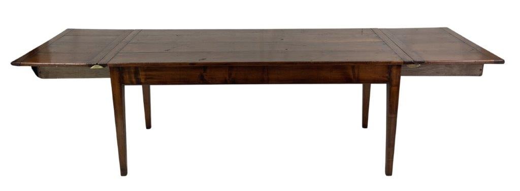 Large British Farm Table: A substantial walnut dining table of traditional pinned construction featuring a beaded apron and elegant tapered legs. This versatile piece includes a clever internal storage system where the extensi