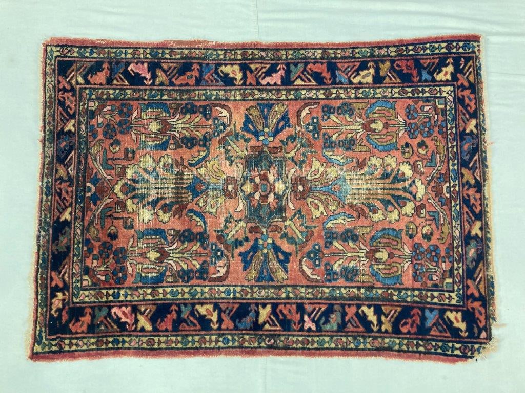 Antique Persian Handwoven Rug: Antique handwoven Persian rug from the Northwest Persian weaving tradition featuring stylized plant and floral designs arranged within a geometric framework. Constructed with a wool pile and