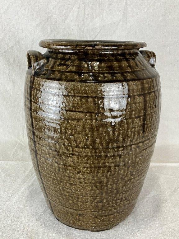North Carolina Alkaline Glaze Stoneware Storage Jar: Rich, runny green alkaline glaze flows over a robust rounded form with applied handles and incised ring decoration. Measures approximately 14 1/2" H x 9 3/4" in diameter. Natural glaze imperfections