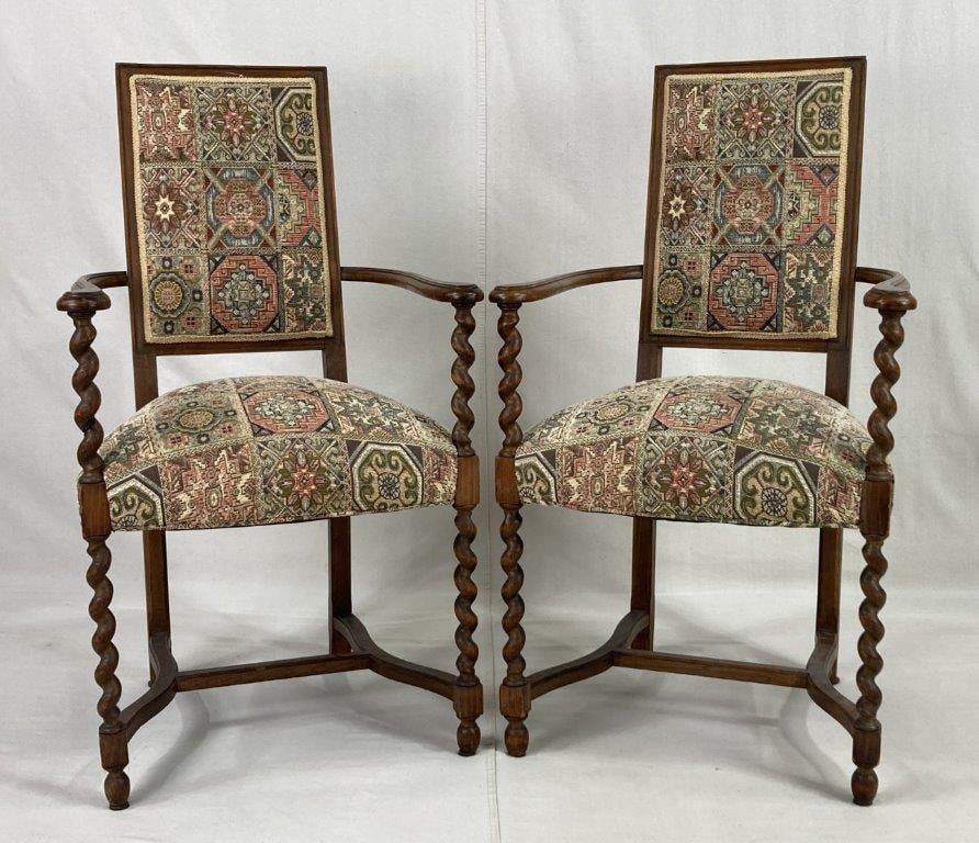 Pair of Walnut Barley Twist Armchairs: A stately and well-crafted duo featuring intricately carved barley twist posts and elegant curving arms that frame a rich walnut construction, each expertly upholstered in a sophisticated