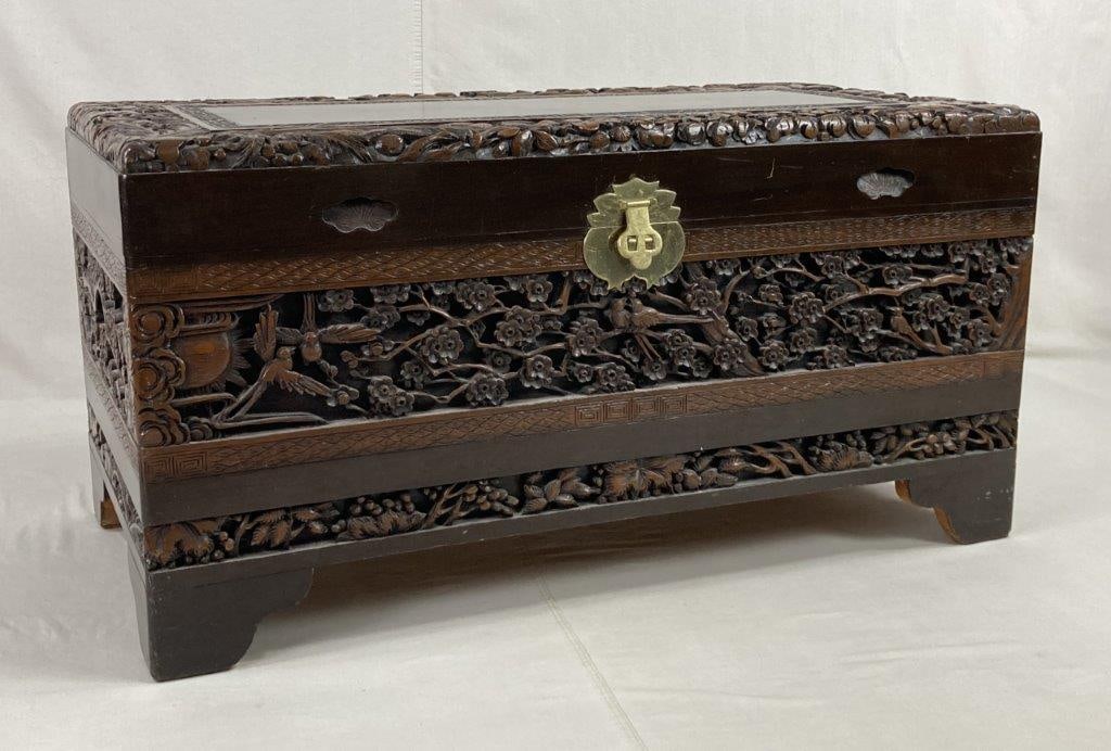 Chinese Carved Chest: An exceptional storage piece featuring intricate high-relief carvings across its mahogany surfaces, depicting a traditional bird and cherry blossom motif. The chest is finished in a rich dark patina