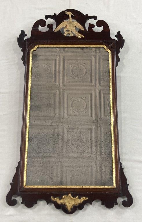 Georgian Mirror: Georgian mirror featuring a gilt phoenix above a mahogany frame with a gilt liner. The frame combines warm mahogany tones with gilt accents for an elegant presentation. Measures approximately 38" H x