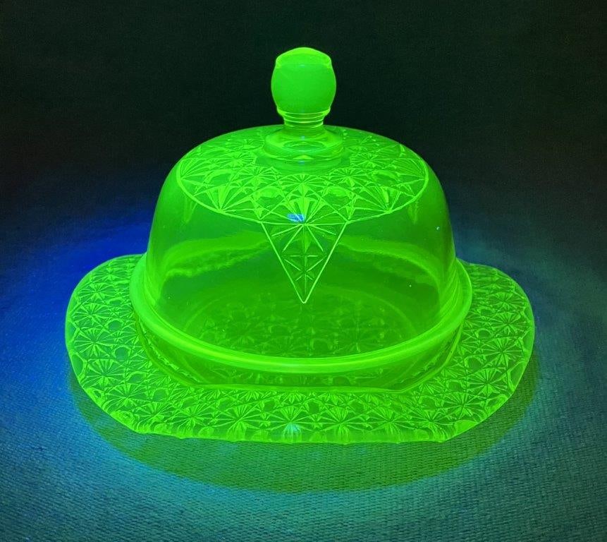 Mosser "Queen Daisy and Button" Uranium Glass Covered Butter Dish: A luminous and meticulously detailed butter dish crafted in a striking "Vaseline" or canary yellow-green hue, featuring the intricate and classic Queen Daisy and Button geometric pattern that