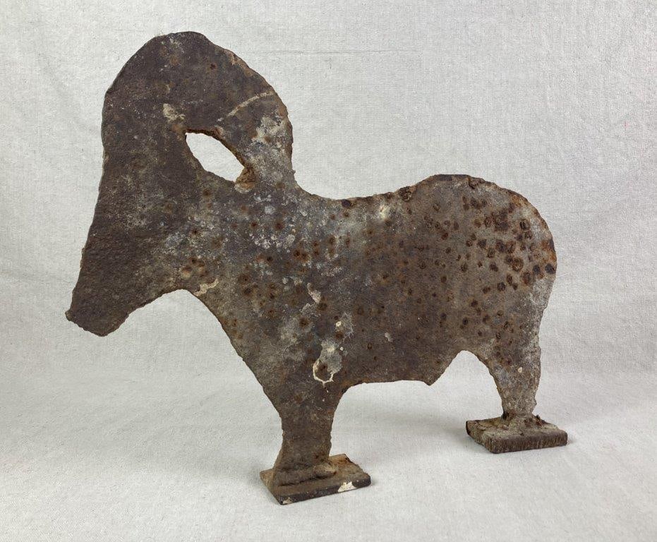 Iron Ram Sculpture: Antique iron silhouette sculpture depicting a ram with a rusted patina. Measures approximately 13 1/4" H x 16 1/2" W. Rust present consistent with age. 