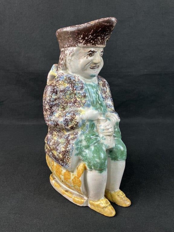 Spatterware Toby Jug: 19th century English Staffordshire example depicting a seated Toby figure with characteristic rounded form and expressive features. Decorated in the traditional spatterware glazing technique.