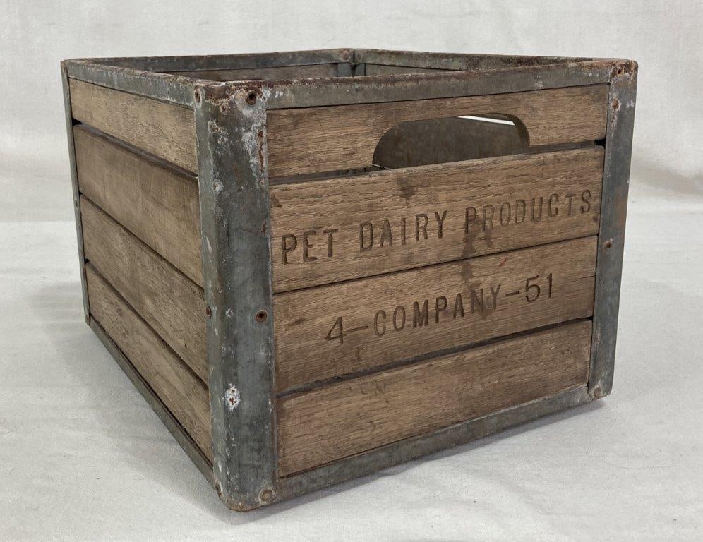 Pet Dairy Milk Crate: Pet Dairy milk crate of wood and tin construction with a tin bottom and cutout handles at the sides. Measures approximately 10 3/4" H x 16" W x 13" D. Good condition with some wear consistent with