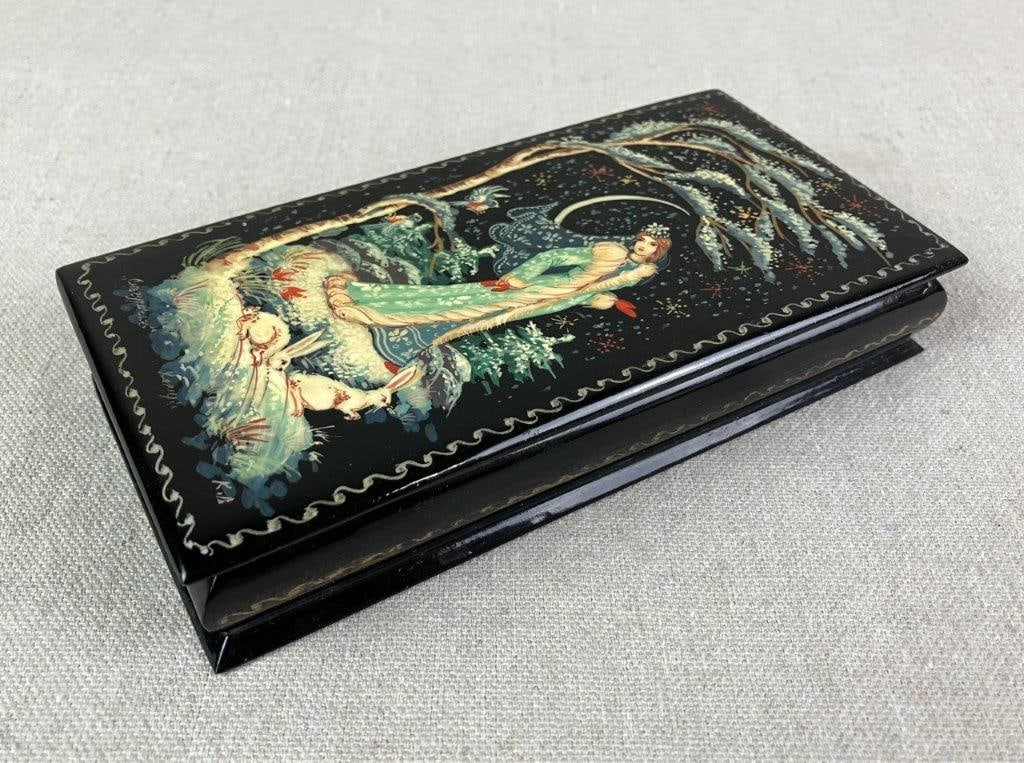 Hand Painted Russian Lacquer Box: Likely depicting the Snow Maiden from Russian fairy tales in a winter landscape with nearby rabbits. Black lacquer exterior with a vibrant red interior, featuring a delicately painted miniature