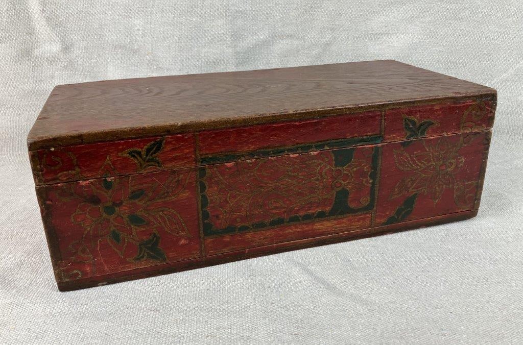 Folk Art Hand Painted Box: Red lacquer finish with gilt and black floral decoration, displaying a rich wood patina. Measures approximately 4 3/8" H x 13 1/8" W x 6 1/8" D. Age-consistent wear. 